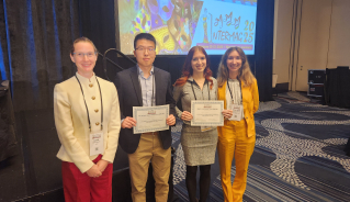 JILA graduate student Anya Grafov (second to the right) holds up her award for Best Lightning Talk