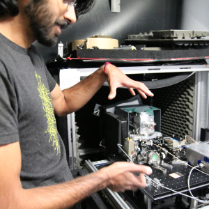 Graduate student Dhruv Kedar explains the laser set up within JILA and NIST Fellow Jun Ye's laboratory