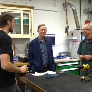 Senator Hickenlooper (center) talks to JILA's instrument shop head Kyle Thatcher (left) and JILA instrument maker Hans Green (right).