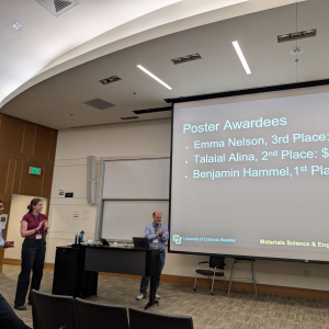 JILA graduate student Emma Nelson (left) claps as the award winners are announced at the CU Boulder Innovation in Materials Symposium 2024