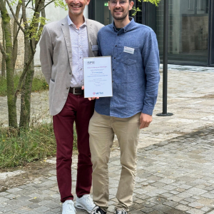 JILA postdoctoral researcher Simon Scheidegger (right) stands with physicist Hugo Lehmann to receive the prestigious 2024 METAS Award 