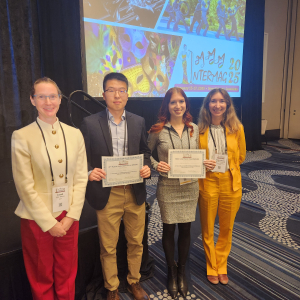 JILA graduate student Anya Grafov (second to the right) holds up her award for Best Lightning Talk