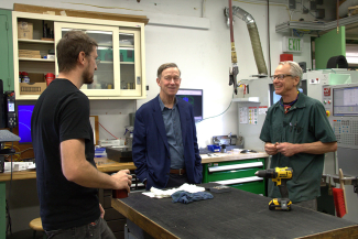 Senator Hickenlooper (center) talks to JILA's instrument shop head Kyle Thatcher (left) and JILA instrument maker Hans Green (right).