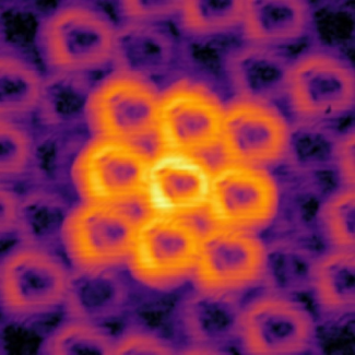 Doughnut-shaped beams of light scatter away from two incredibly small structures with different repeating patterns. (Credit: Wang, et al., 2023, "Optica")