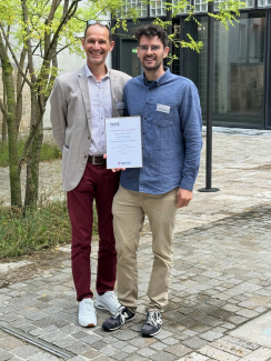 JILA postdoctoral researcher Simon Scheidegger (right) stands with physicist Hugo Lehmann to receive the prestigious 2024 METAS Award 