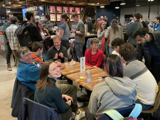 JILA Fellow and CU Boulder Physics Professor Murray Holland and JILA graduate Student Annette Carroll smile for the camera during the Life After JILA Alumni Mixer at the Rayback Collective in Boulder Colorado