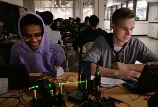 two students doing an experiment with fiber optics