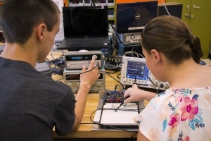 Two studnets working on electronics. 