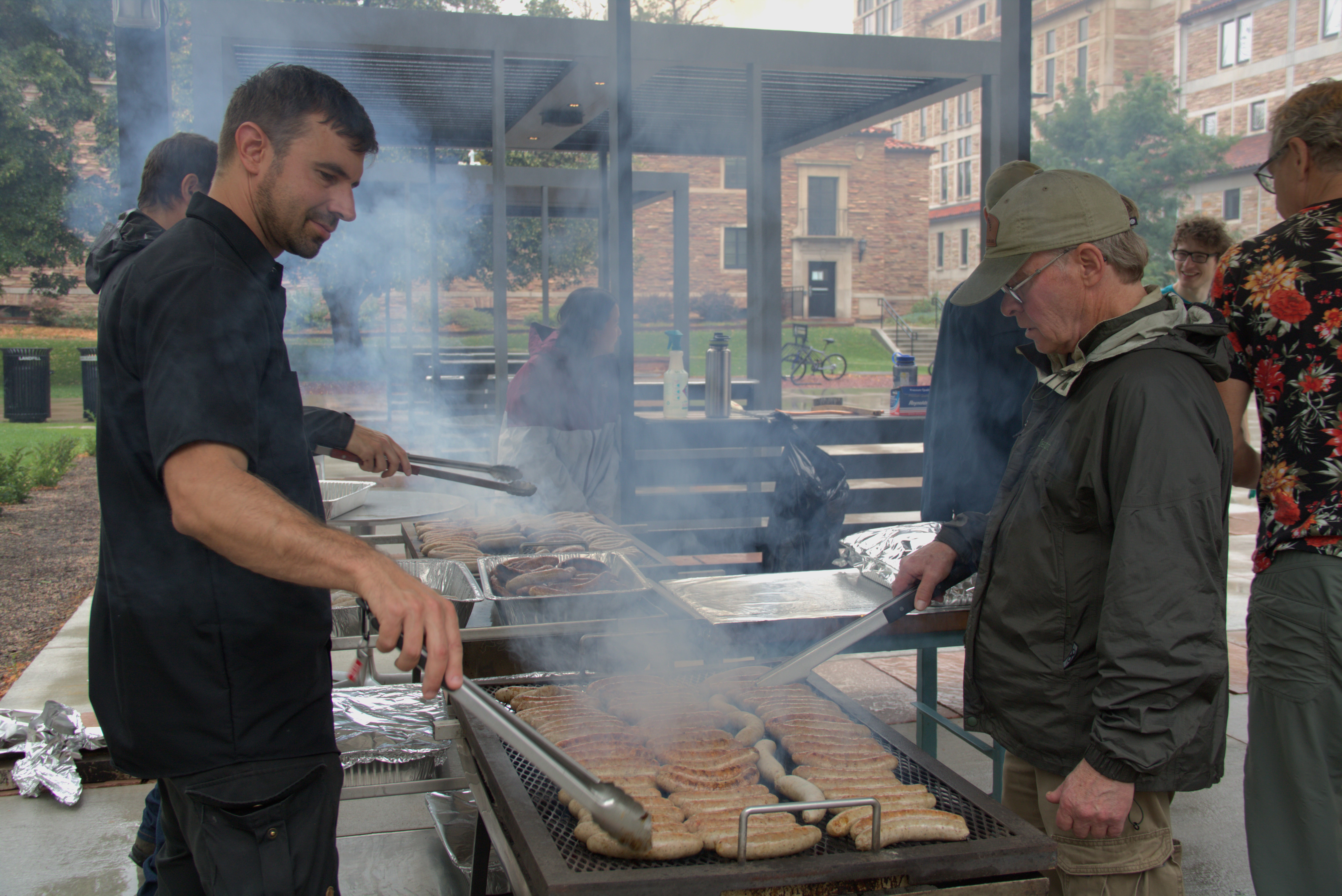 JILA instrument maker Danny Warren (left) grills some brats with fellow instrument maker Kim Hagen (right) during the cookout