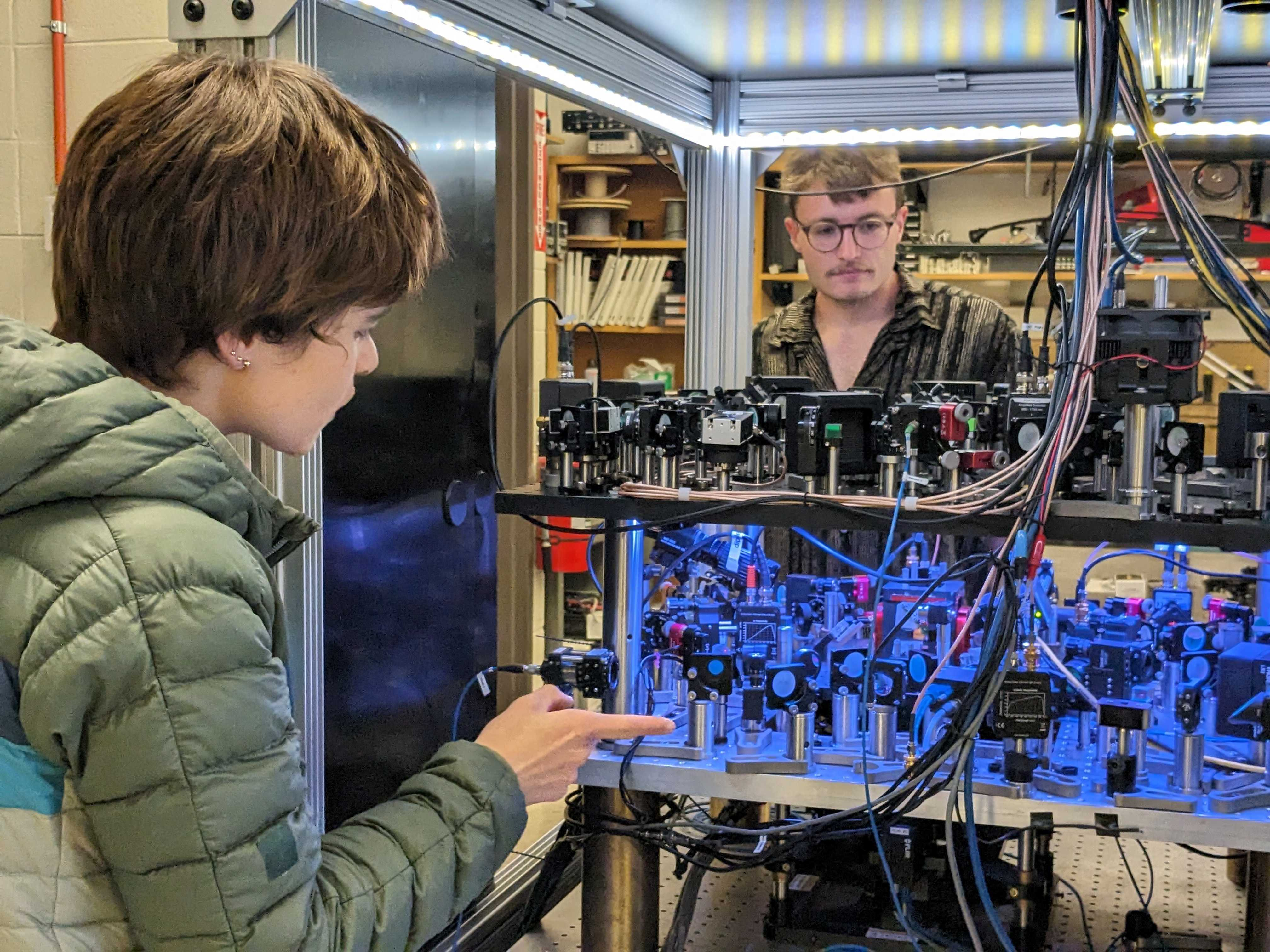 JILA postdoctoral researcher Catie LeDesma (left) discusses the new quantum metrology set up with JILA graduate student Kendall Mehling (right)