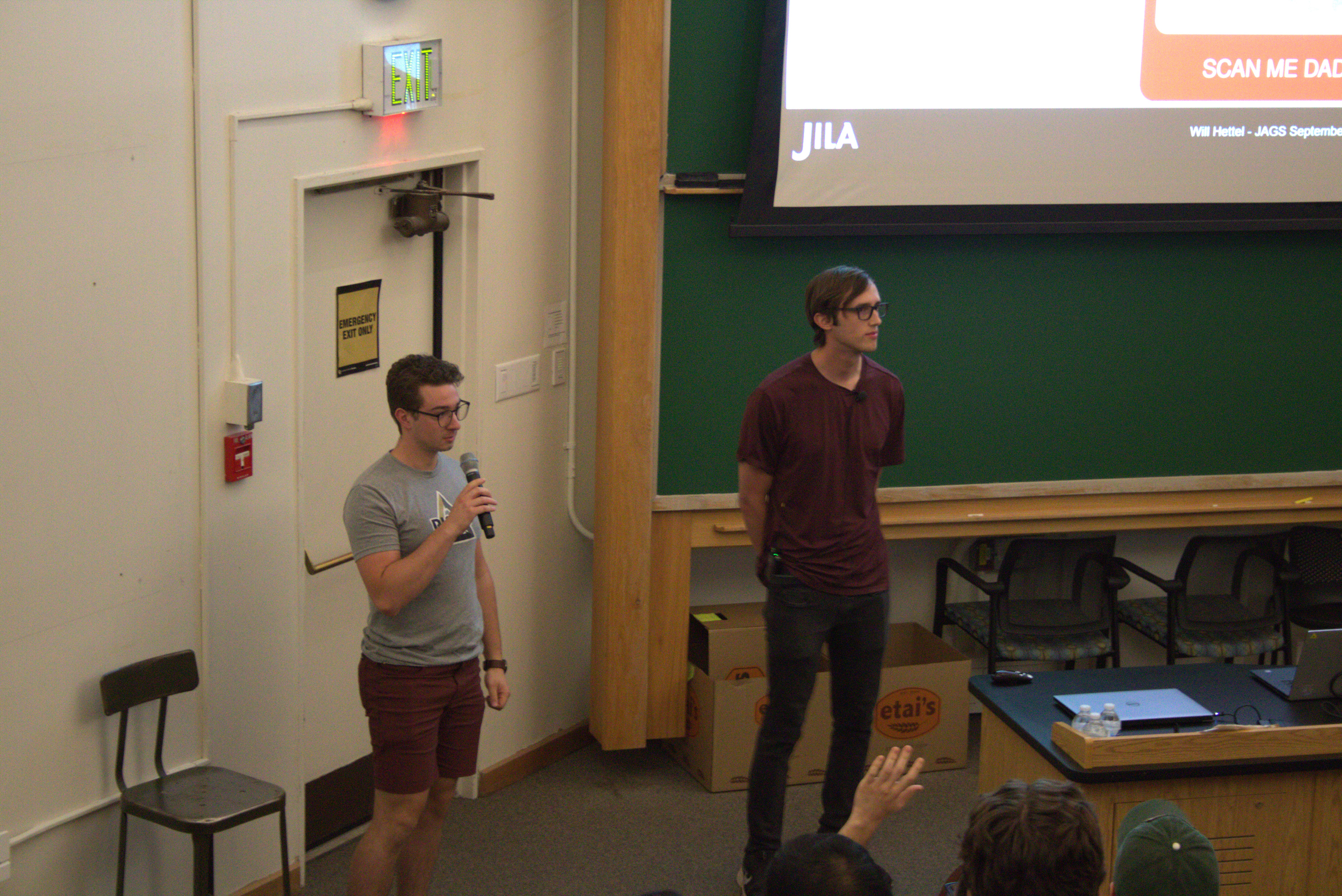 JILA graduate student Keegan Finger (left) fields questions for JILA graduate student Will Hettel (right) during the JAGS Seminar