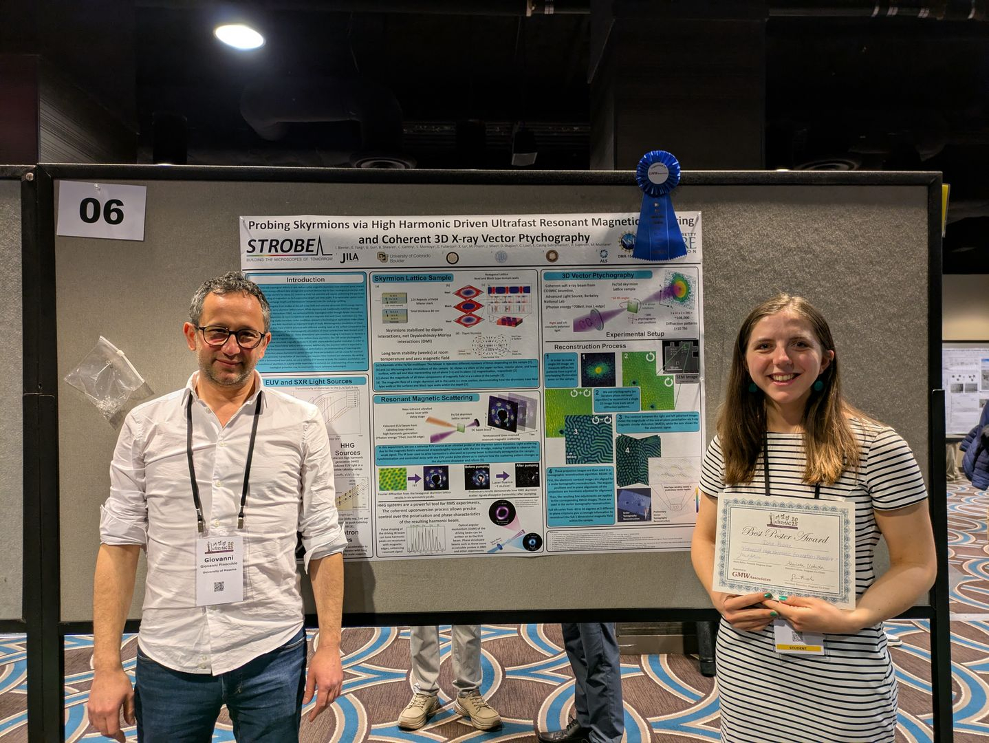 JILA graduate student Iona Binnie (right) holds up her certificate for Best Poster