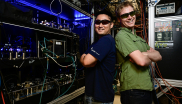 JILA Postdoc Kyungtae Kim (left) poses with JILA graduate student Alex Aeppli (right) in front of the strontium atomic clock