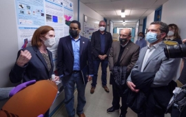 Top: From left to right, physicist Margaret Murnane, Rep. Joe Neguse, Chancellor Philip DiStefano and CU President Todd Saliman in Murnane's lab at JILA; bottom: Murnane discusses the promise of new microscope technologies during the JILA tour. (Credits: Glenn Asakawa/CU Boulder)
